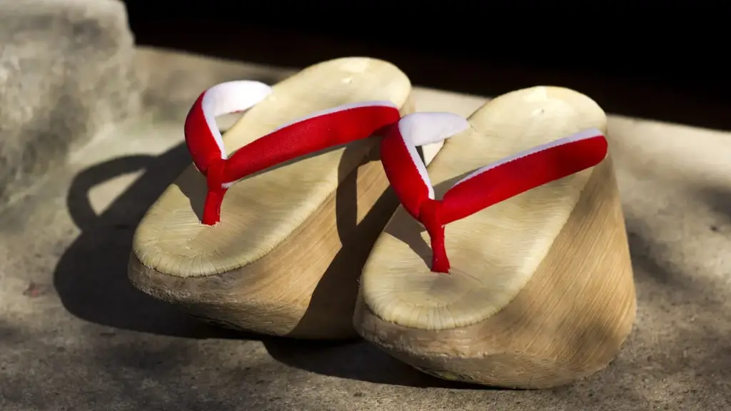 A pair of Japanese okobo in paulownia wood with red straps, the tall sandals worn by apprentice geisha