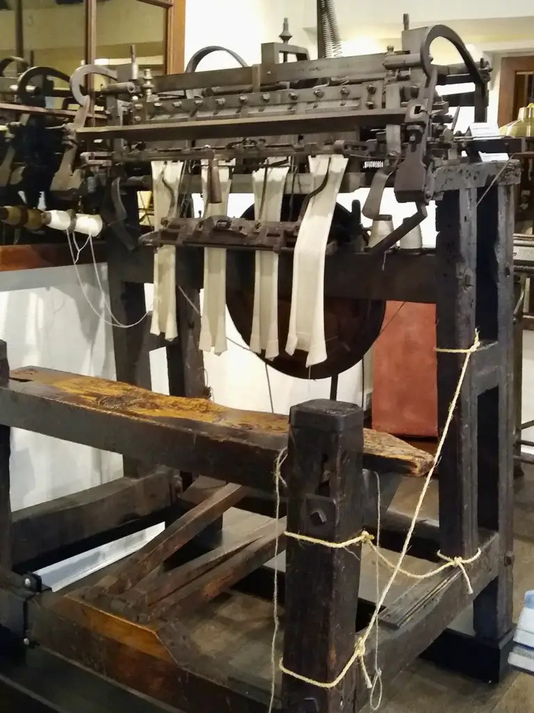 A 19th-century wood and iron stocking frame able to knit four stockings at once, on display at the Godalming Museum in England